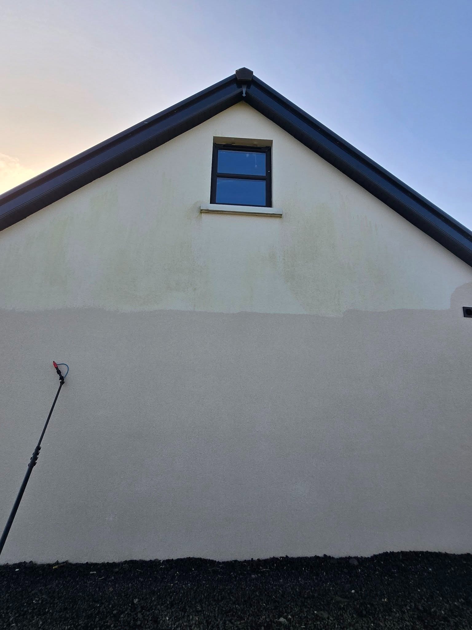 Pristine white gable end wall after professional render clean in Newtownabbey